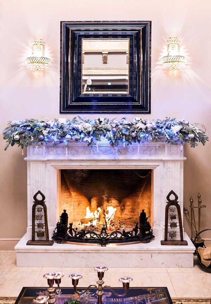 Burning fireplace decorated for Christmas in country house